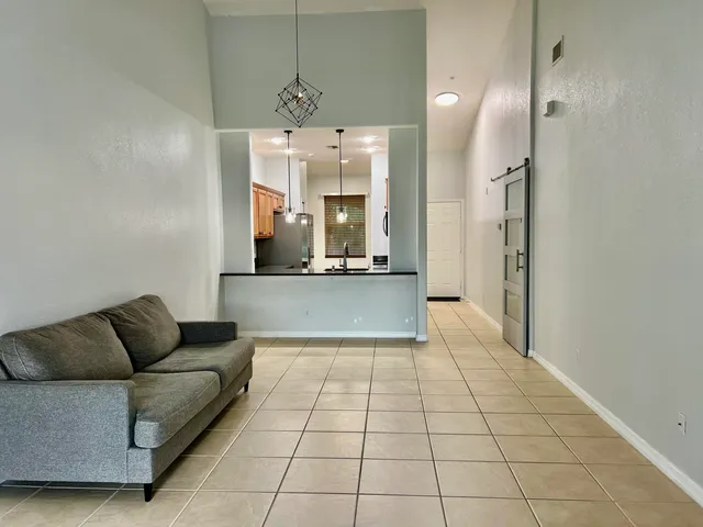a living room with a couch and a chandelier