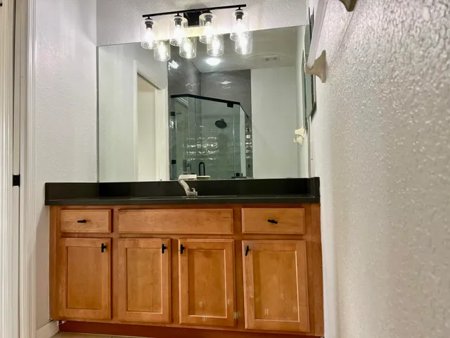 a bathroom with a mirror and a sink