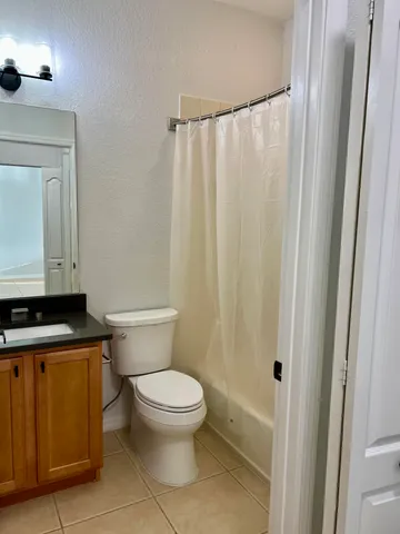 a white toilet sitting next to a bath tub