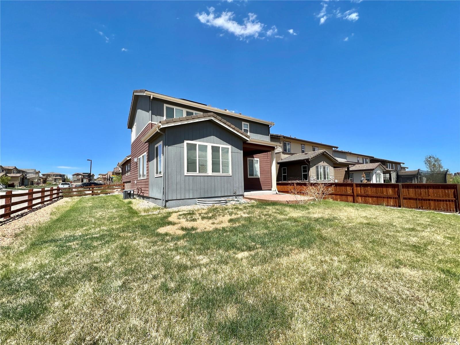 14000 Touchstone Point Parker, CO 80134 - Photo 16 of 19 a front view of a house with a garden and yard