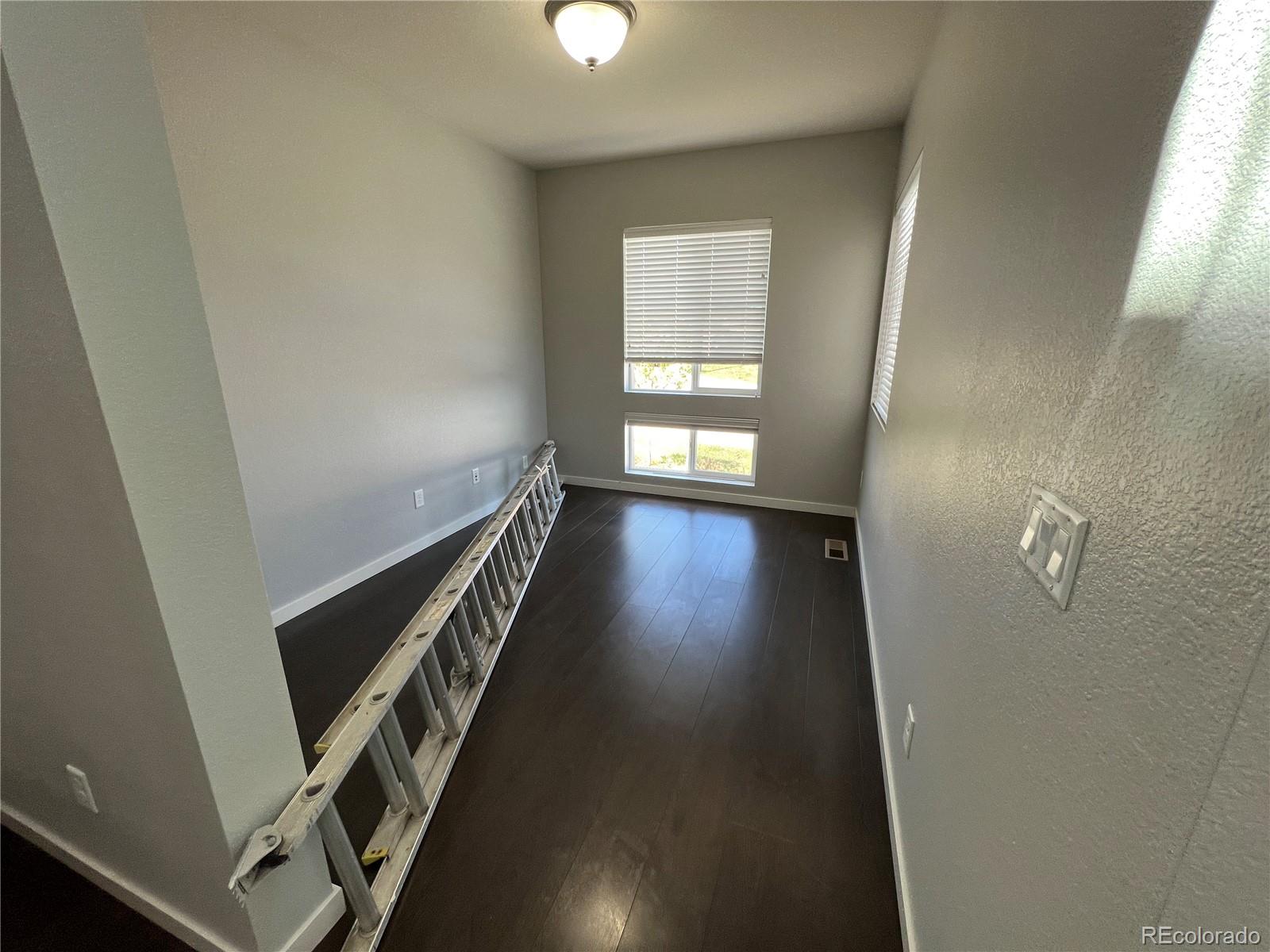 14000 Touchstone Point Parker, CO 80134 - Photo 4 of 19 a view of an empty room with wooden floor and stairs