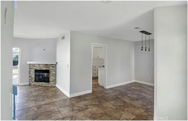 a view of a livingroom with an empty space and a fireplace