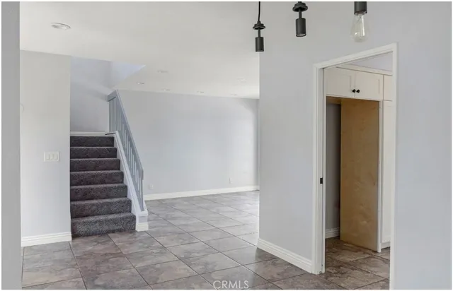 a view of entryway with stairs and white walls