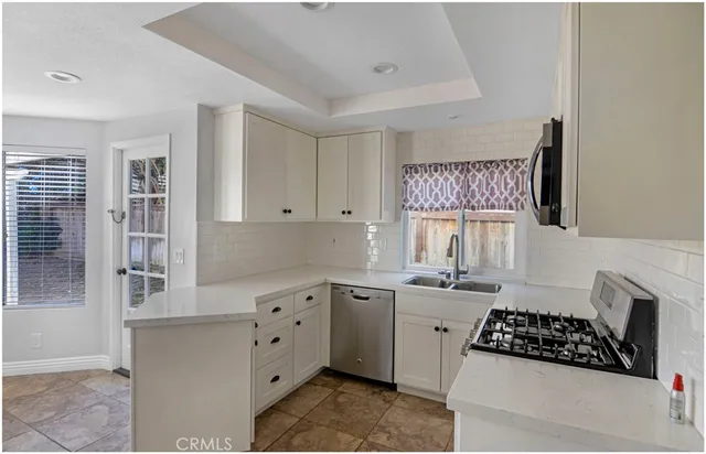 a kitchen with a sink stove and cabinets