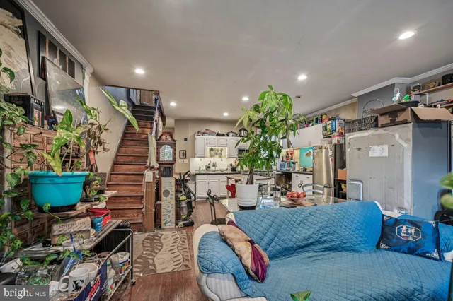 a bedroom with a bed couch and a window
