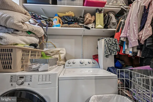 a bedroom with a bed a walk in closet and a window