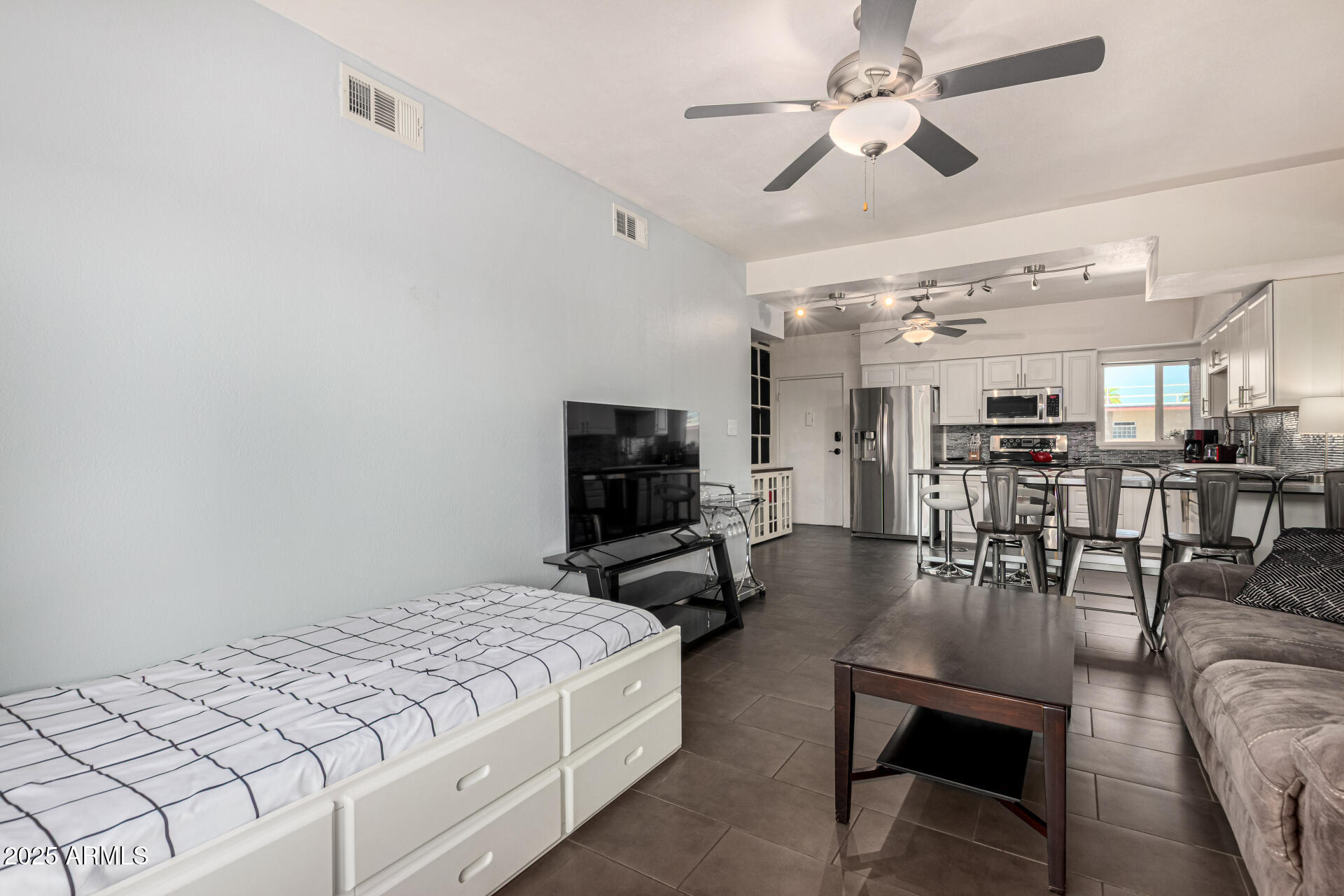 351 East Thomas Road, Unit D505 Phoenix, AZ 85012 - Photo 12 of 28 a bedroom with furniture and a view of kitchen