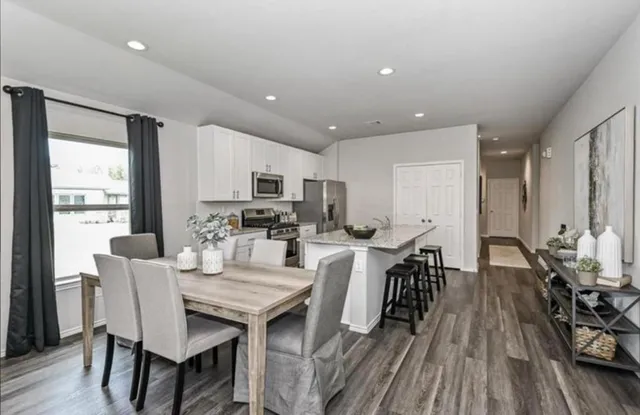 a view of a dining room with furniture window and wooden floor