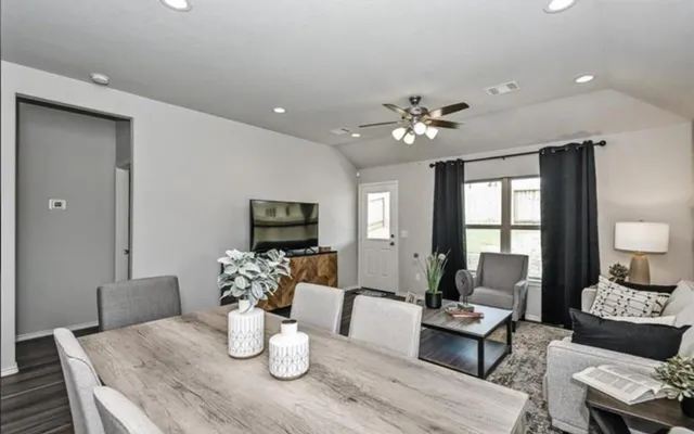 a living room with furniture a fireplace and a flat screen tv