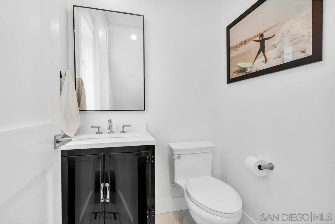 949 D Avenue Coronado, CA 92118 - Photo 9 of 28 a bathroom with a toilet sink and mirror