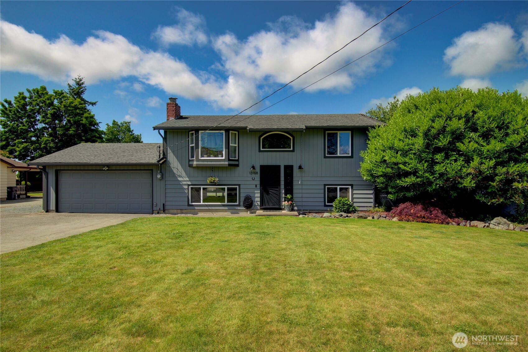 13168 Avon Allen Road Mount Vernon, WA 98273 - Photo 1 of 34 a front view of a house with yard and trees