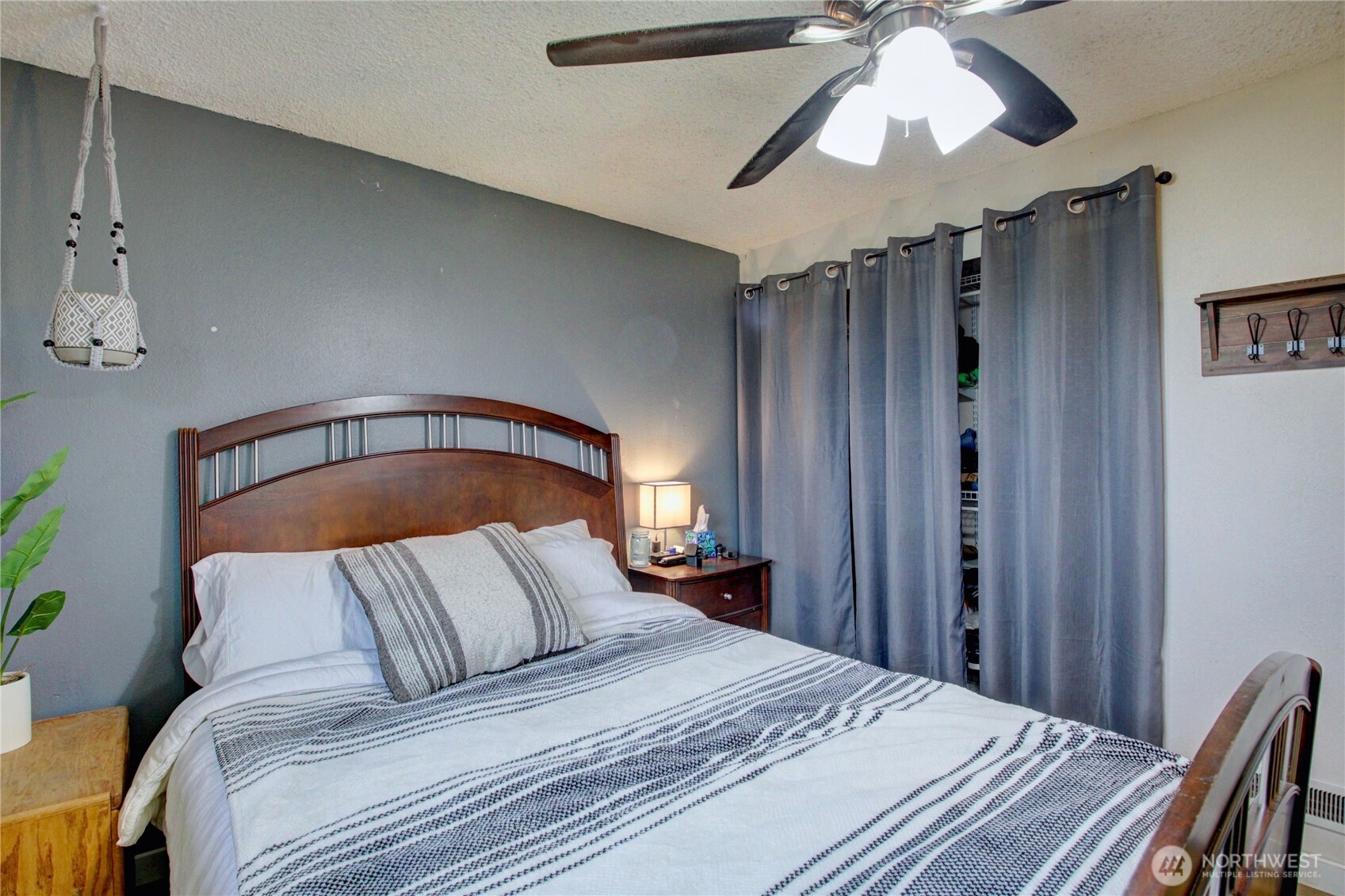 13168 Avon Allen Road Mount Vernon, WA 98273 - Photo 13 of 34 a bedroom with a bed and a chandelier