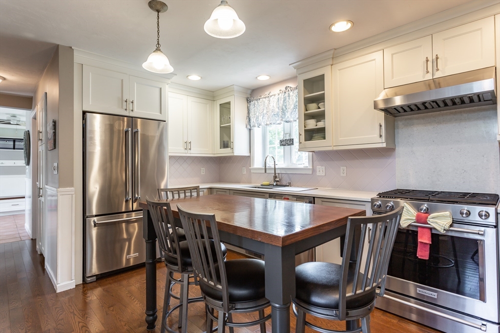 39 Nachaomet Road Lakeville, MA 02347 - Photo 5 of 42 a kitchen with stainless steel appliances granite countertop a refrigerator a stove a sink dishwasher and white cabinets with wooden floor