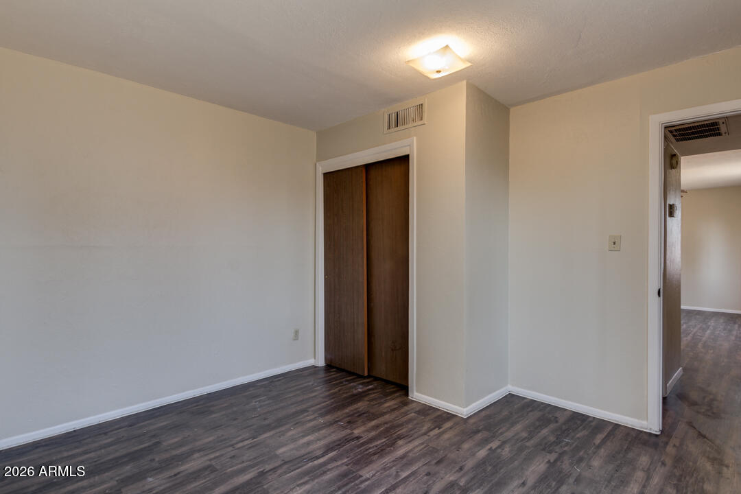 1301 West Indian School Road, Unit B Phoenix, AZ 85013 - Photo 6 of 9 a view of an empty room with wooden floor