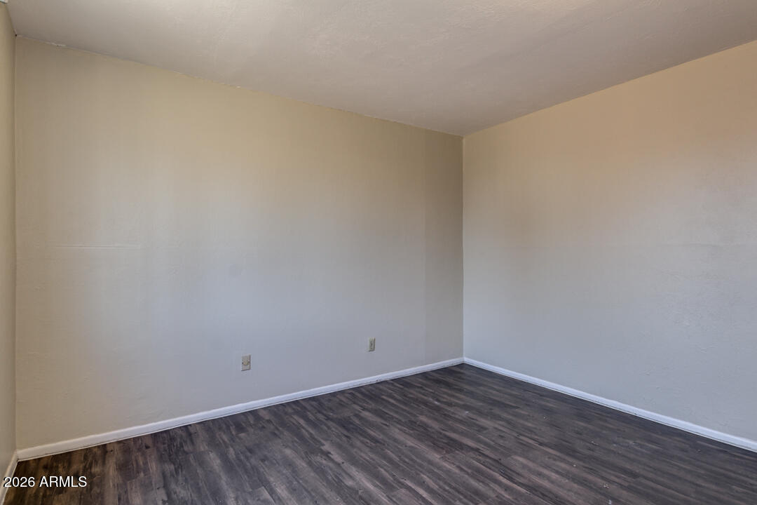 1301 West Indian School Road, Unit B Phoenix, AZ 85013 - Photo 7 of 9 a view of an empty room with wooden floor