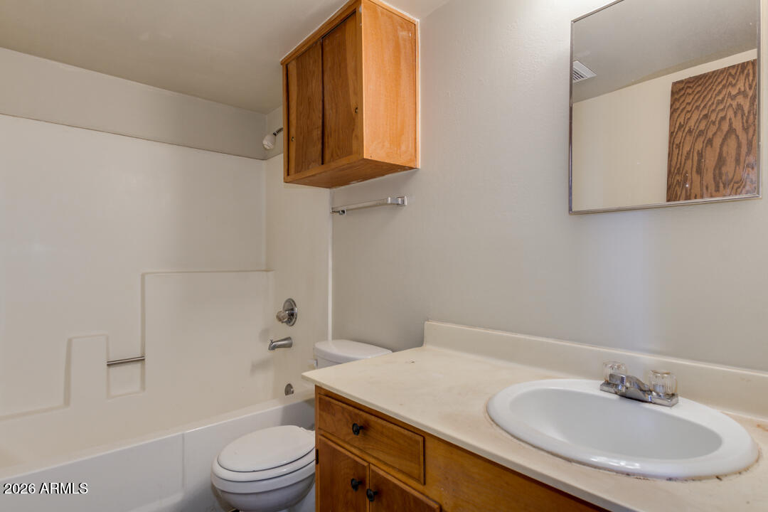 1301 West Indian School Road, Unit B Phoenix, AZ 85013 - Photo 8 of 9 a bathroom with a sink a toilet and shower