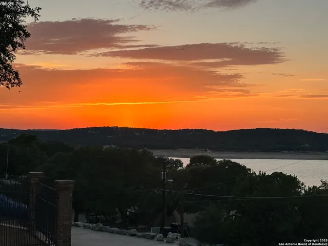 a view of a lake with houses in back