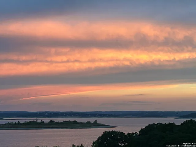 a swimming pool that has lawn chairs