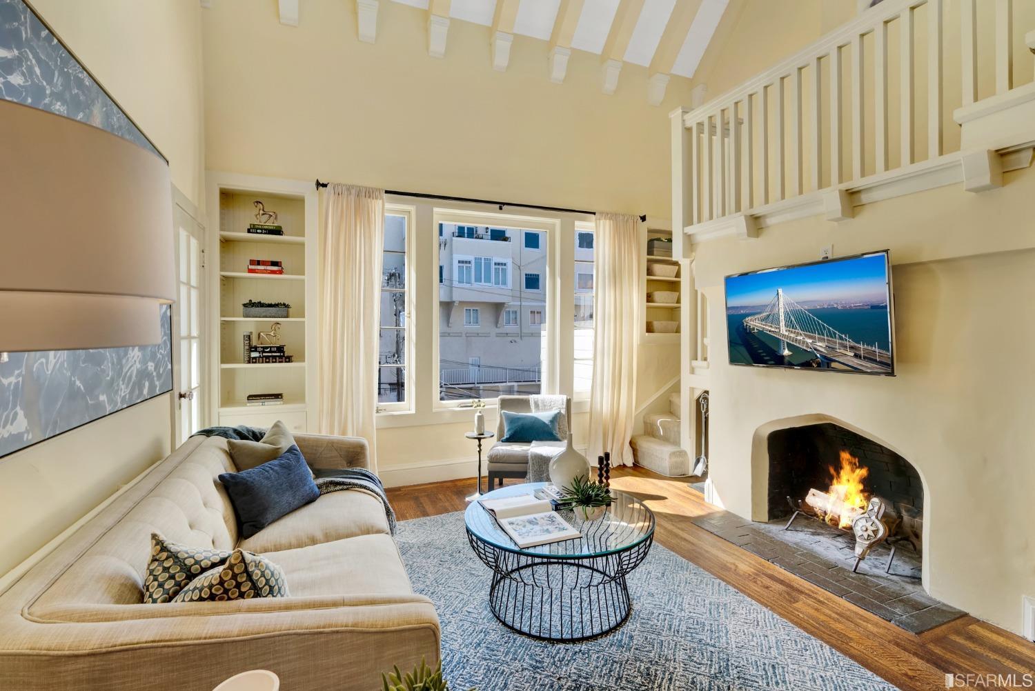 a living room with furniture a fireplace and a flat screen tv