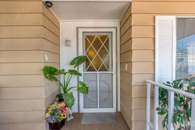 a vase of flowers sitting on a floor