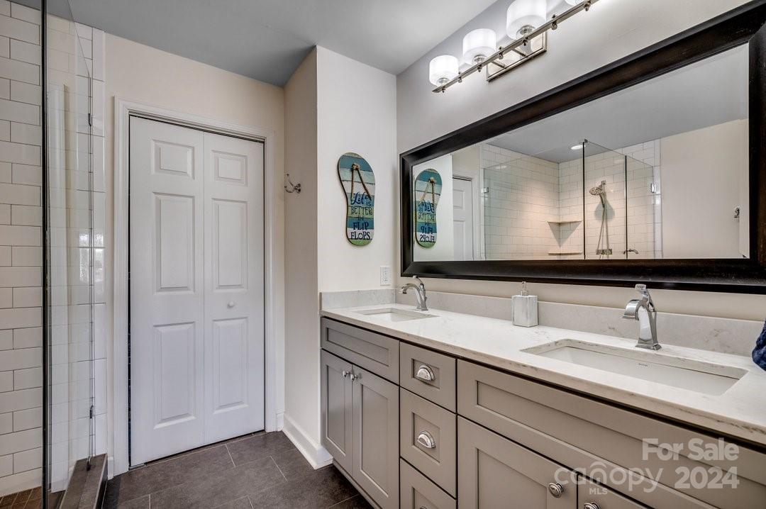 4396 Baldwin Avenue, Unit 40 Little River, SC 29566 - Photo 13 of 24 a bathroom with double vanity sinks and a mirror