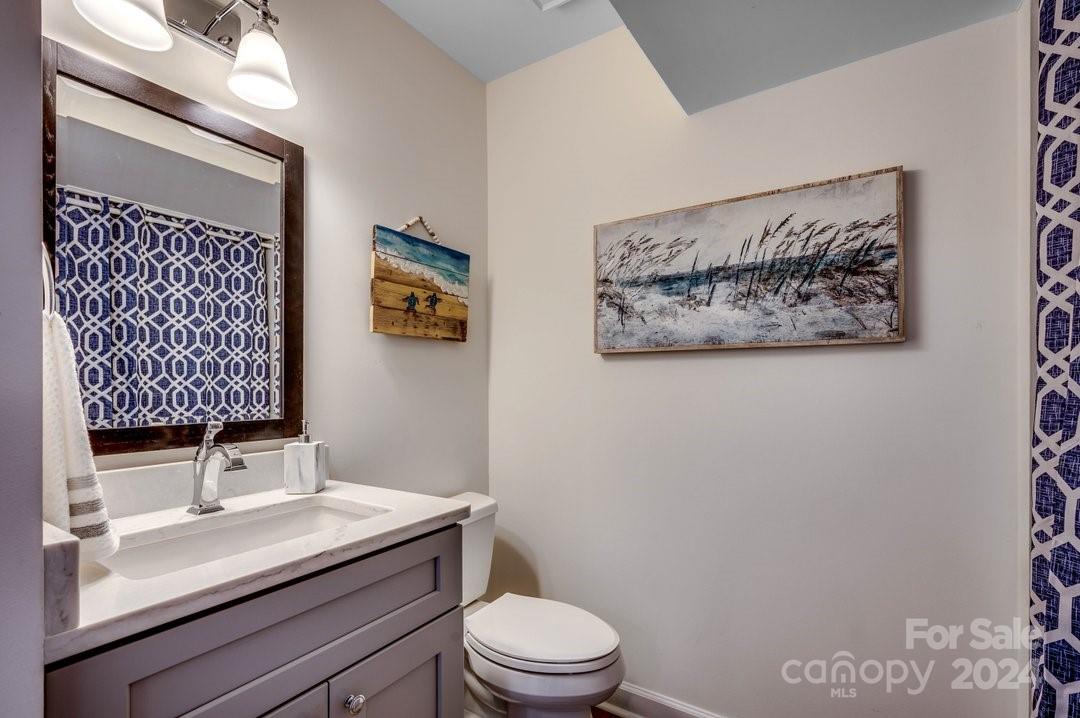 4396 Baldwin Avenue, Unit 40 Little River, SC 29566 - Photo 15 of 24 a bathroom with a toilet a sink and mirror