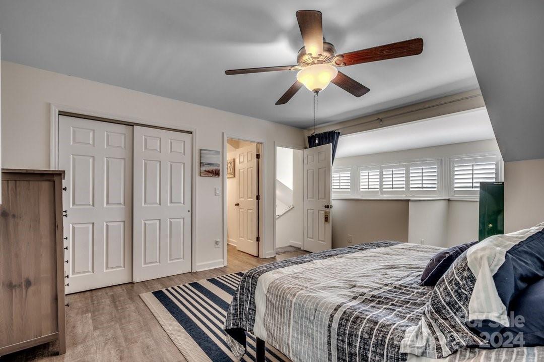 4396 Baldwin Avenue, Unit 40 Little River, SC 29566 - Photo 16 of 24 a bedroom with a large bed and a chandelier