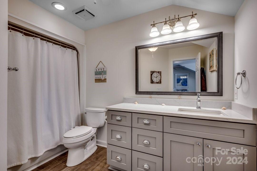 4396 Baldwin Avenue, Unit 40 Little River, SC 29566 - Photo 19 of 24 a bathroom with a toilet a sink and a mirror