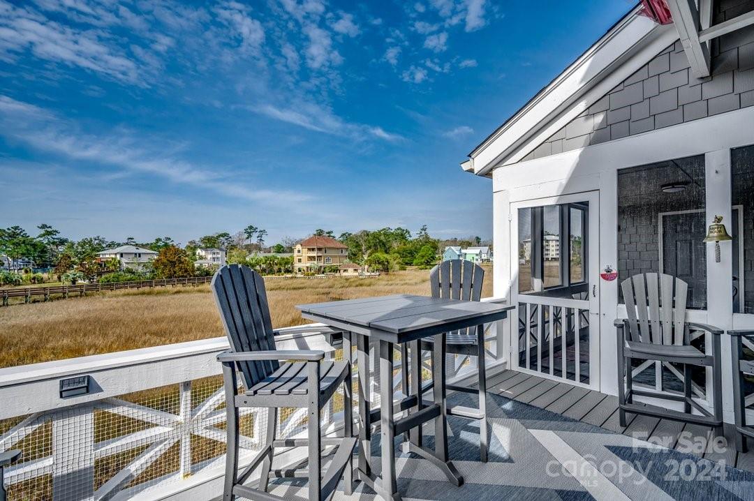 4396 Baldwin Avenue, Unit 40 Little River, SC 29566 - Photo 22 of 24 a view of a chairs and table on the terrace