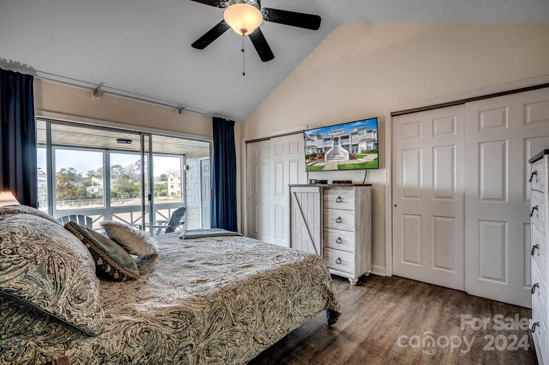 4396 Baldwin Avenue, Unit 40 Little River, SC 29566 - Photo 10 of 24 a bedroom with a large bed and a chandelier