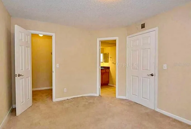 an empty room with windows and a bathroom