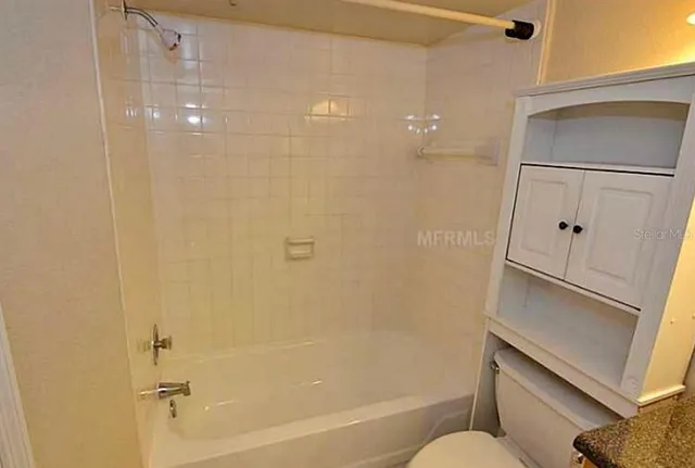 a bathroom with a bathtub and toilet