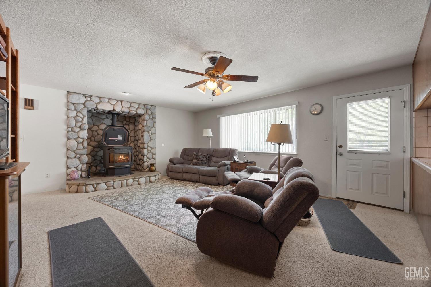 Undisclosed Address Tehachapi, CA 93561 - Photo 18 of 47 a living room with furniture a ceiling fan and a window
