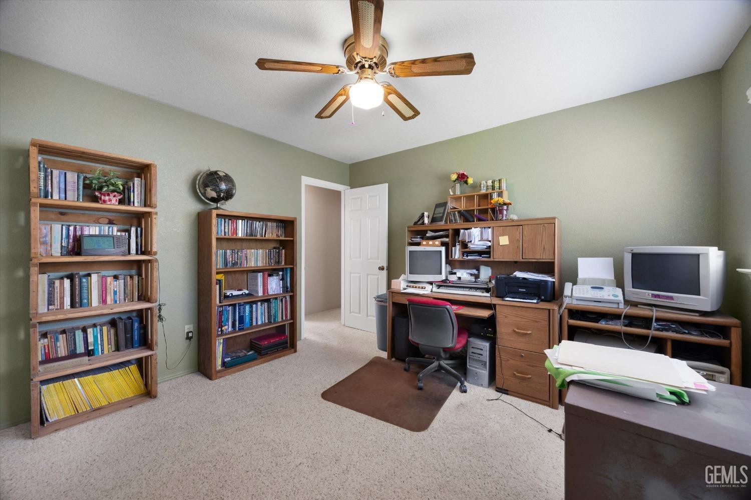 Undisclosed Address Tehachapi, CA 93561 - Photo 33 of 47 a view of a workspace with furniture and a bookshelf