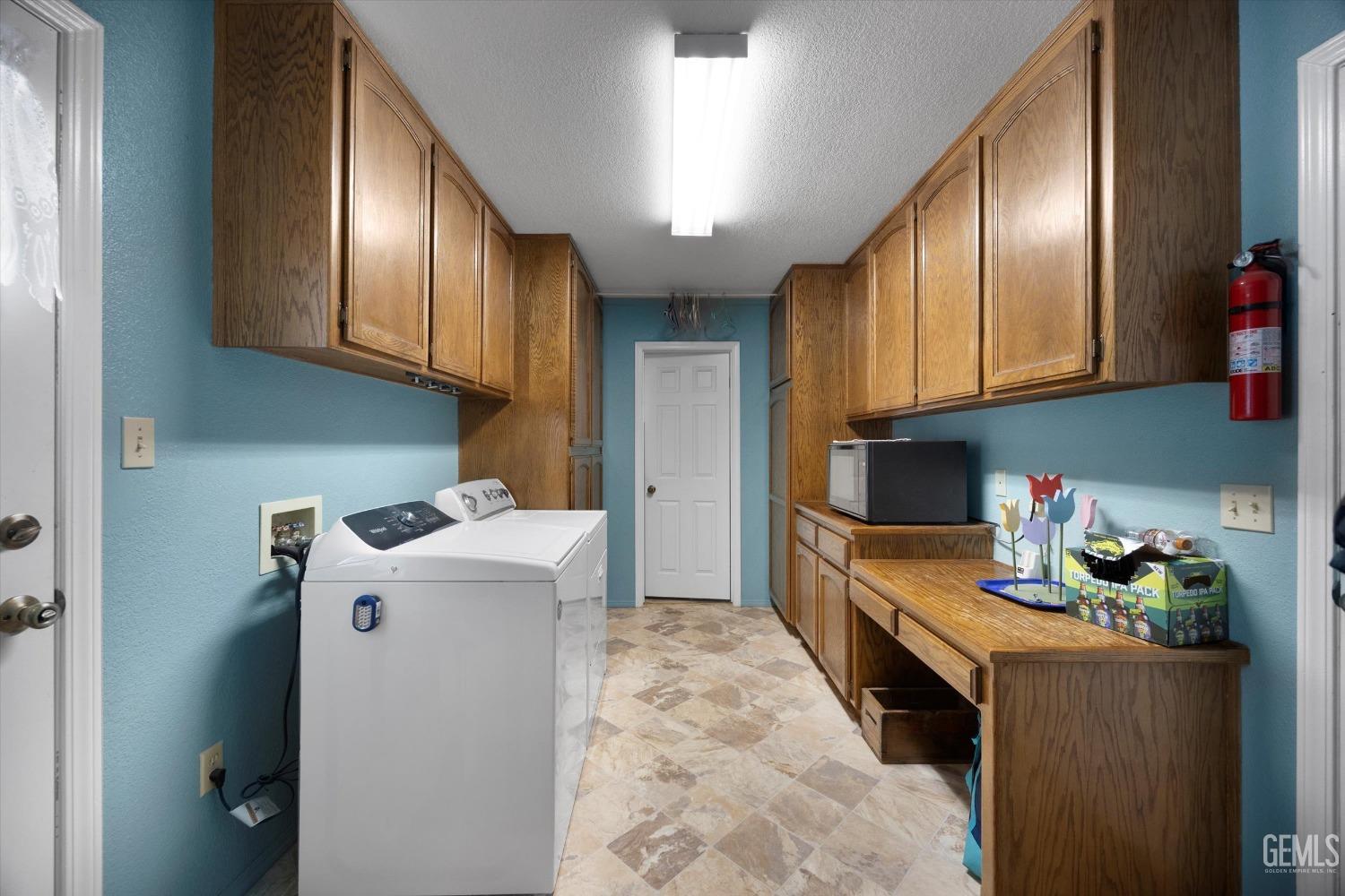 Undisclosed Address Tehachapi, CA 93561 - Photo 35 of 47 a room with cabinets a washer and dryer