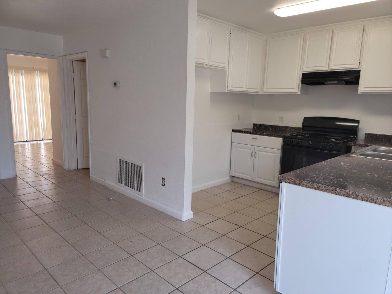43965 Towne Street Indio, CA 92201 - Photo 21 of 31 a kitchen with stainless steel appliances granite countertop a stove a sink and a refrigerator