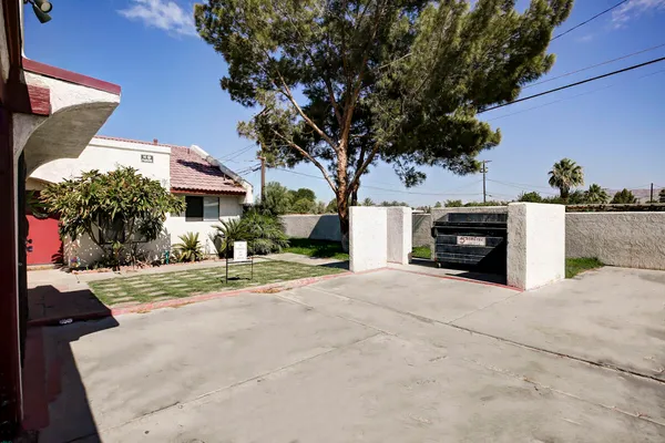 a view of a house with a tree and a yard