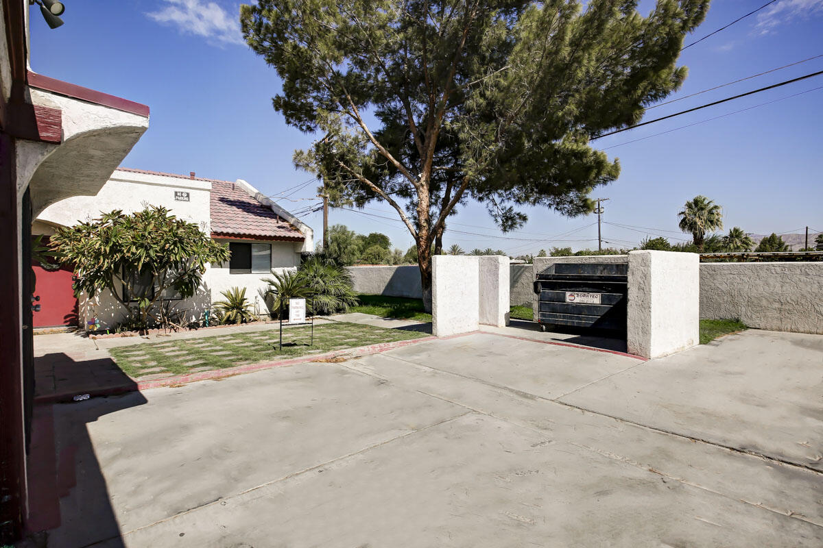43965 Towne Street Indio, CA 92201 - Photo 24 of 31 a view of a house with a tree and a yard