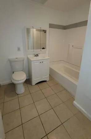 a bathroom with a sink a toilet and bathtub
