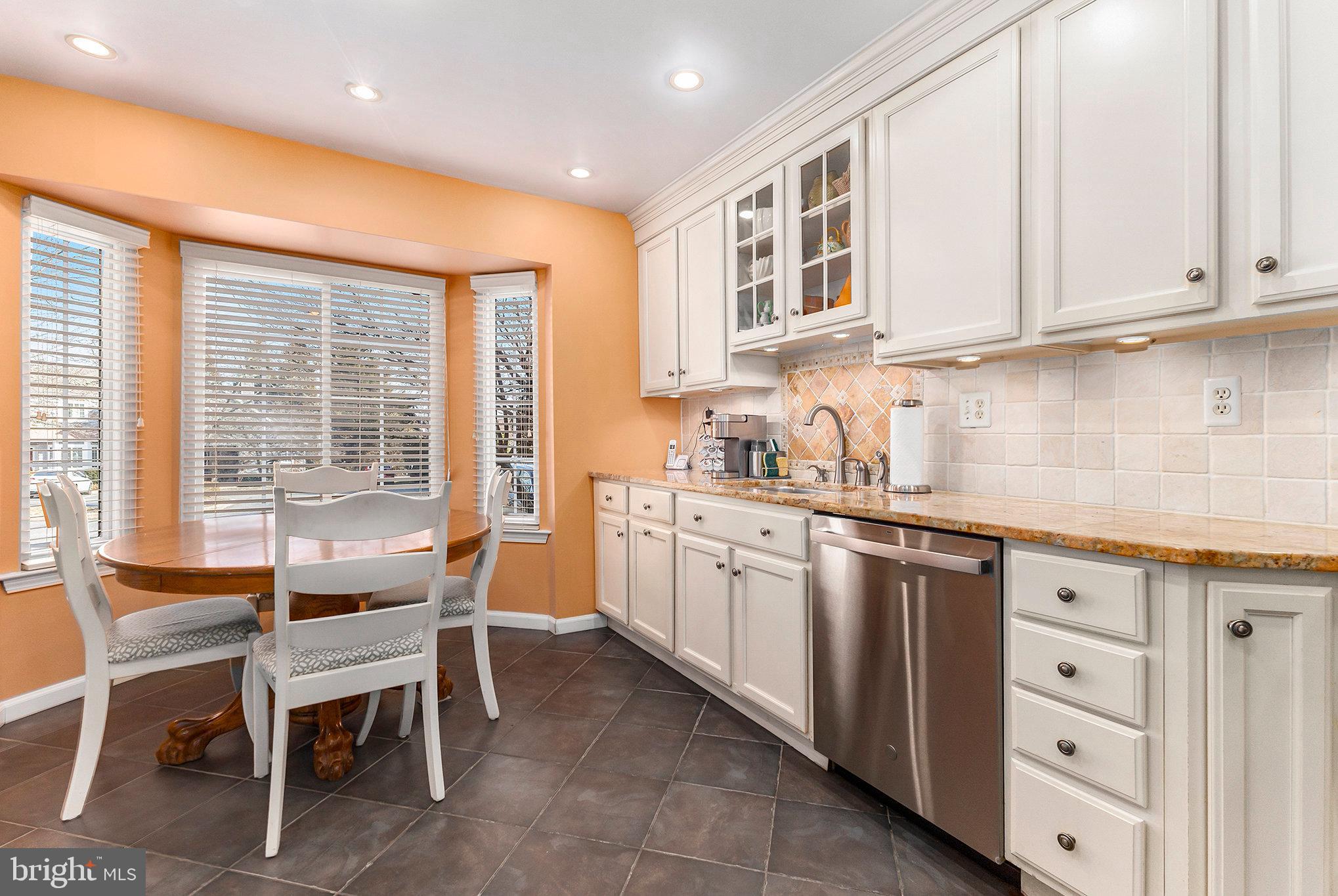 6 Lantern Lane Chesterbrook, PA 19087 - Photo 14 of 37 a kitchen with granite countertop a table chairs stove and cabinets