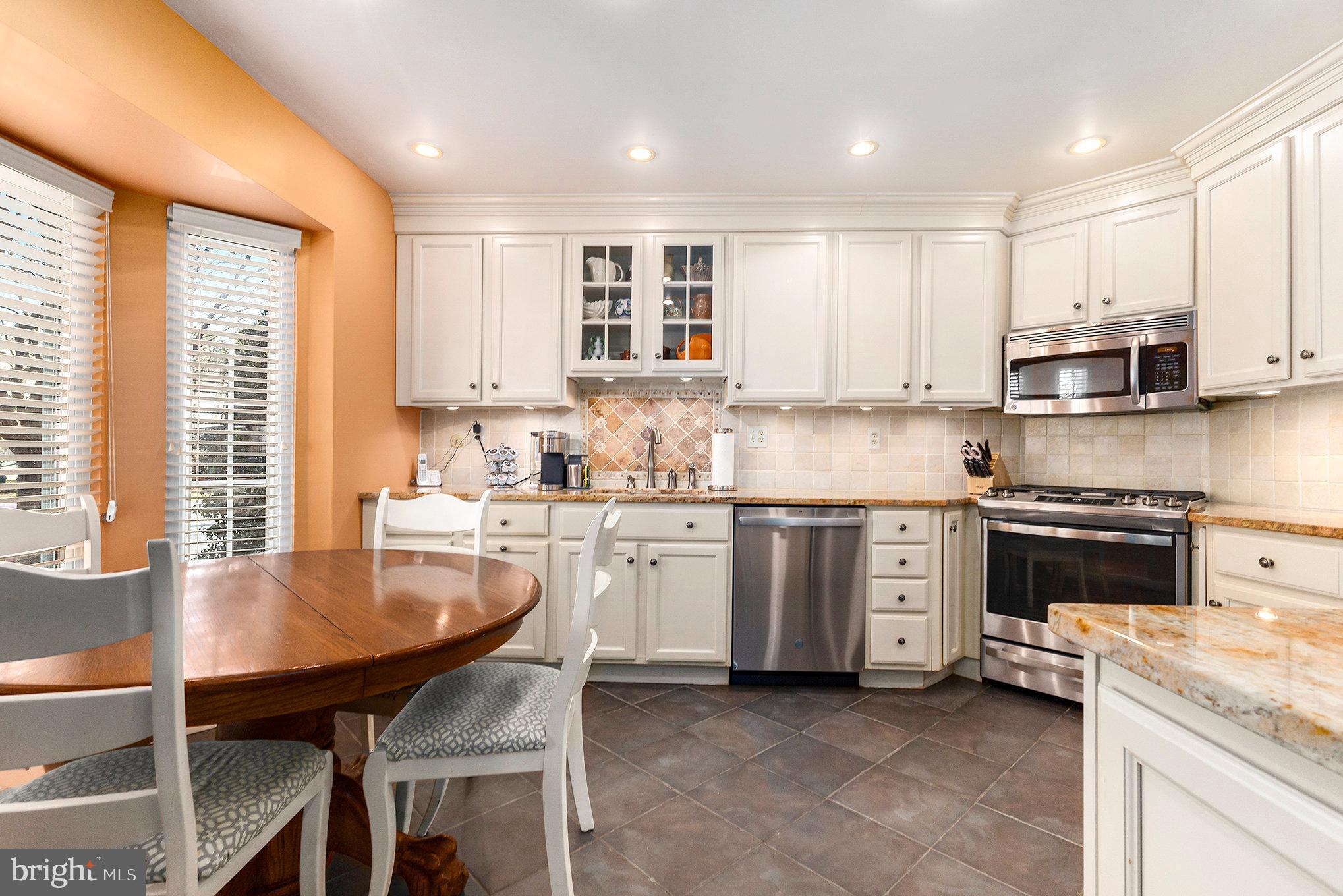 6 Lantern Lane Chesterbrook, PA 19087 - Photo 15 of 37 a kitchen with stainless steel appliances granite countertop a stove top oven a sink dishwasher and white cabinets with wooden floor