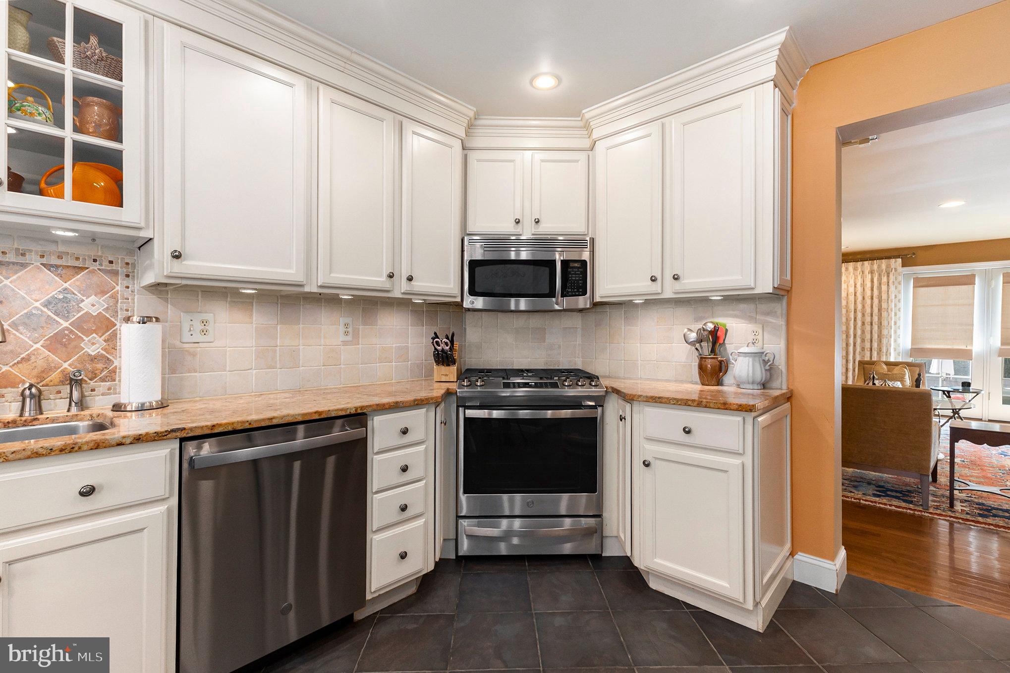 6 Lantern Lane Chesterbrook, PA 19087 - Photo 16 of 37 a kitchen with stainless steel appliances granite countertop a stove a sink and white cabinets