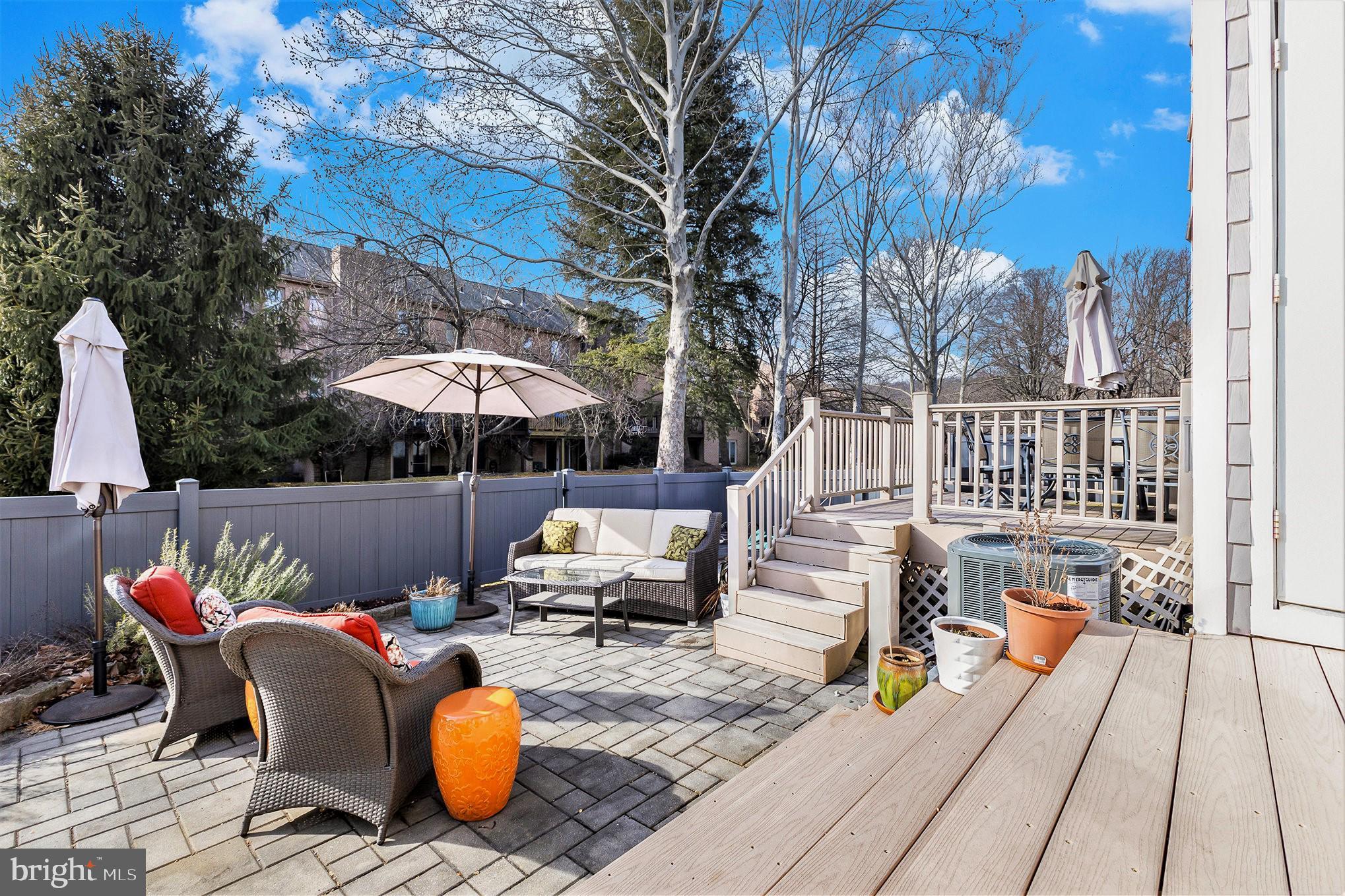 6 Lantern Lane Chesterbrook, PA 19087 - Photo 32 of 37 a view of a patio with couches table and chairs under an umbrella with barbeque grill and wooden floor