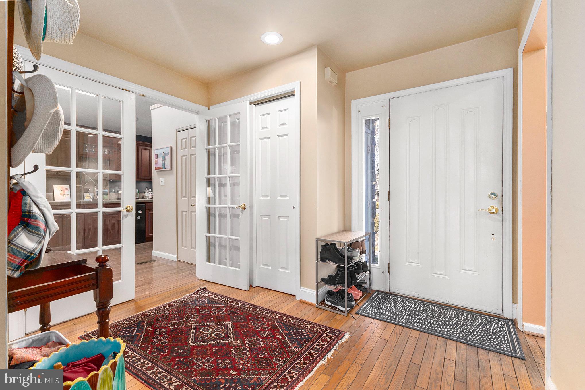 6 Lantern Lane Chesterbrook, PA 19087 - Photo 5 of 37 a view of a hallway with wooden floor and windows