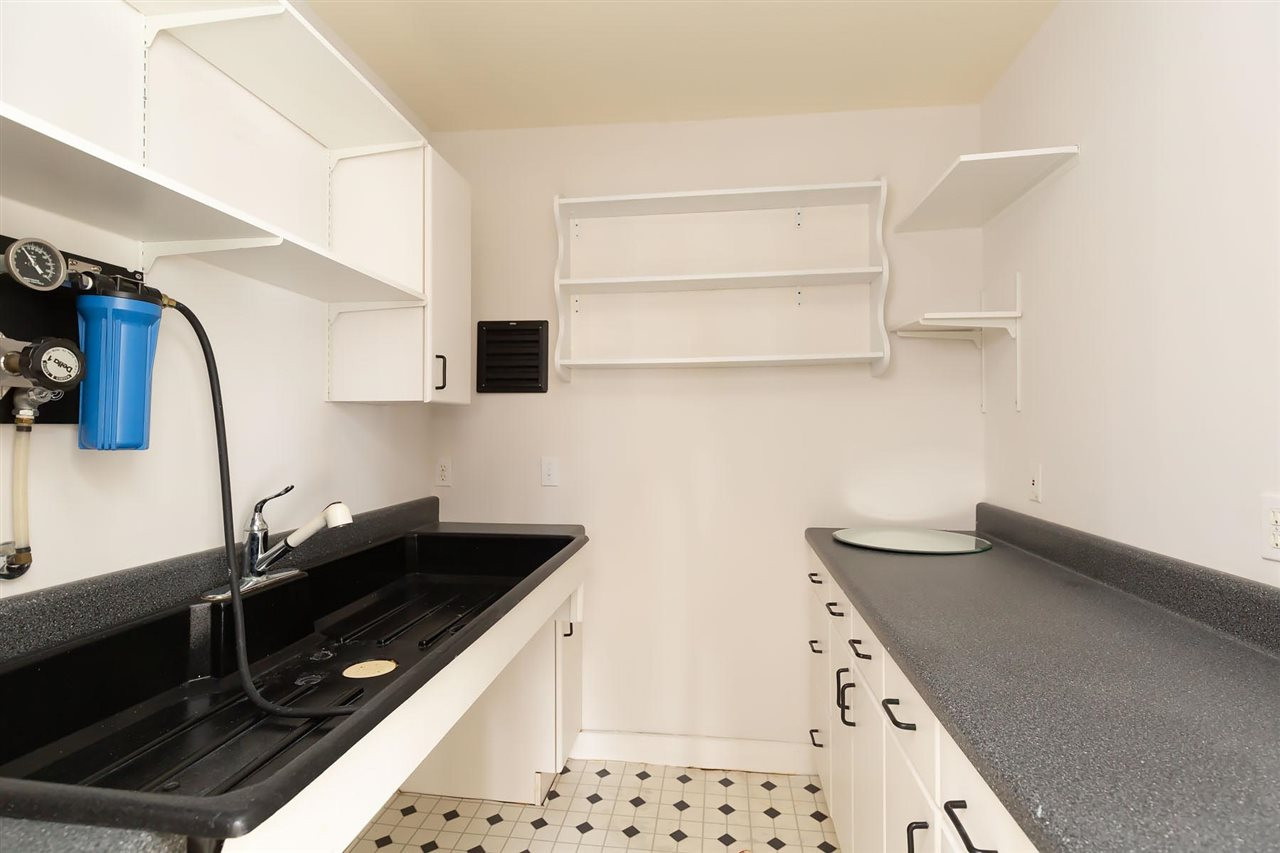 2119 Cowper Drive Raleigh, NC 27608 - Photo 28 of 30 Utility sink with cabinet storage and built in shelving inside Studio. Space used for Dark Room. Studio