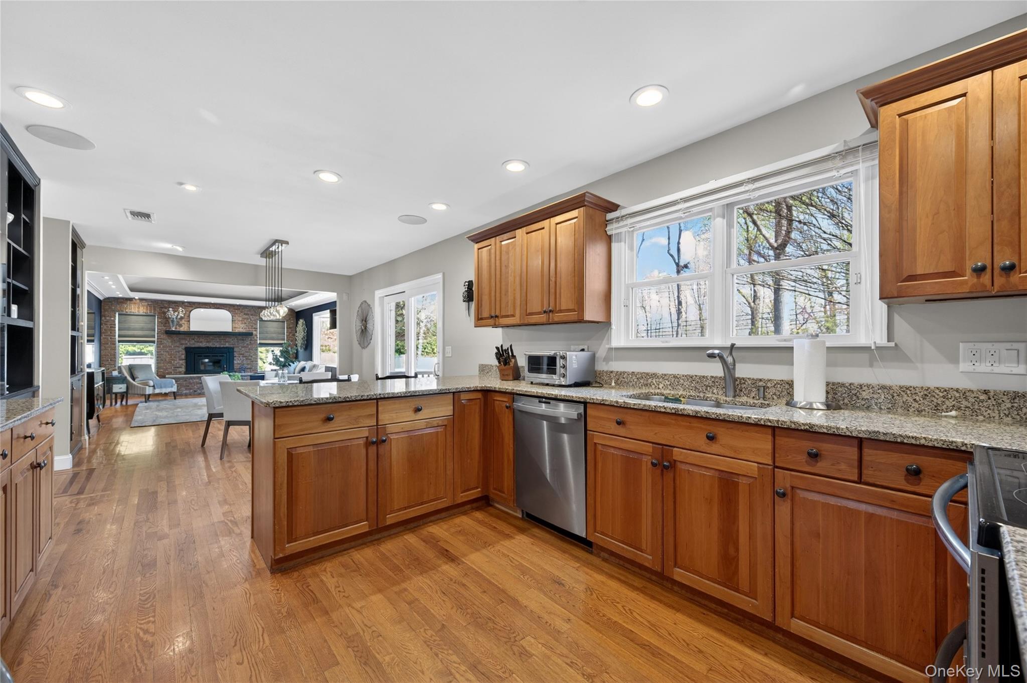21 Midland Street Cold Spring Harbor, NY 11724 - Photo 13 of 44 a kitchen with stainless steel appliances granite countertop wooden cabinets a sink dishwasher a stove and a refrigerator with wooden floor