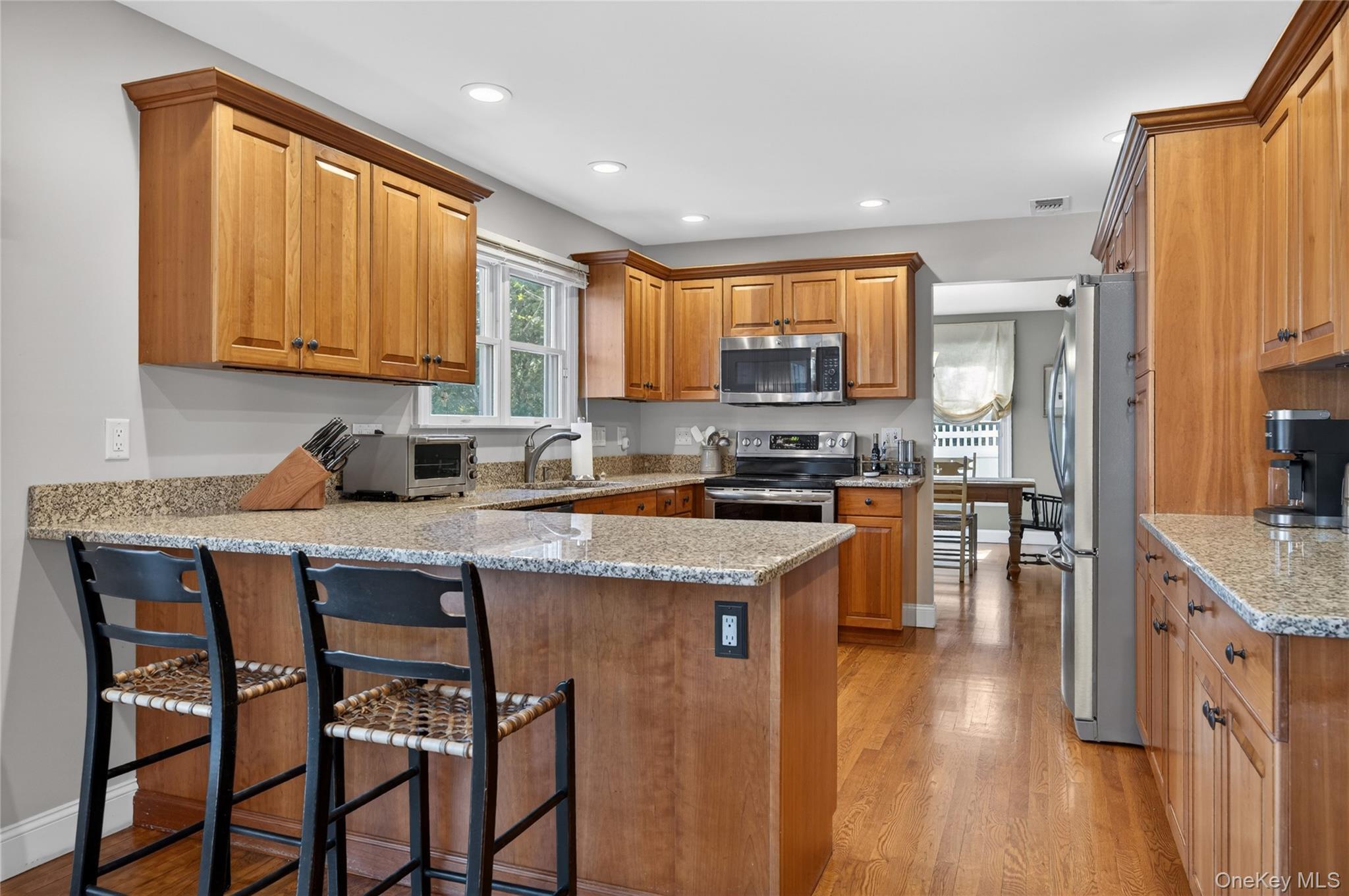 21 Midland Street Cold Spring Harbor, NY 11724 - Photo 14 of 44 a kitchen with a table chairs sink and cabinets