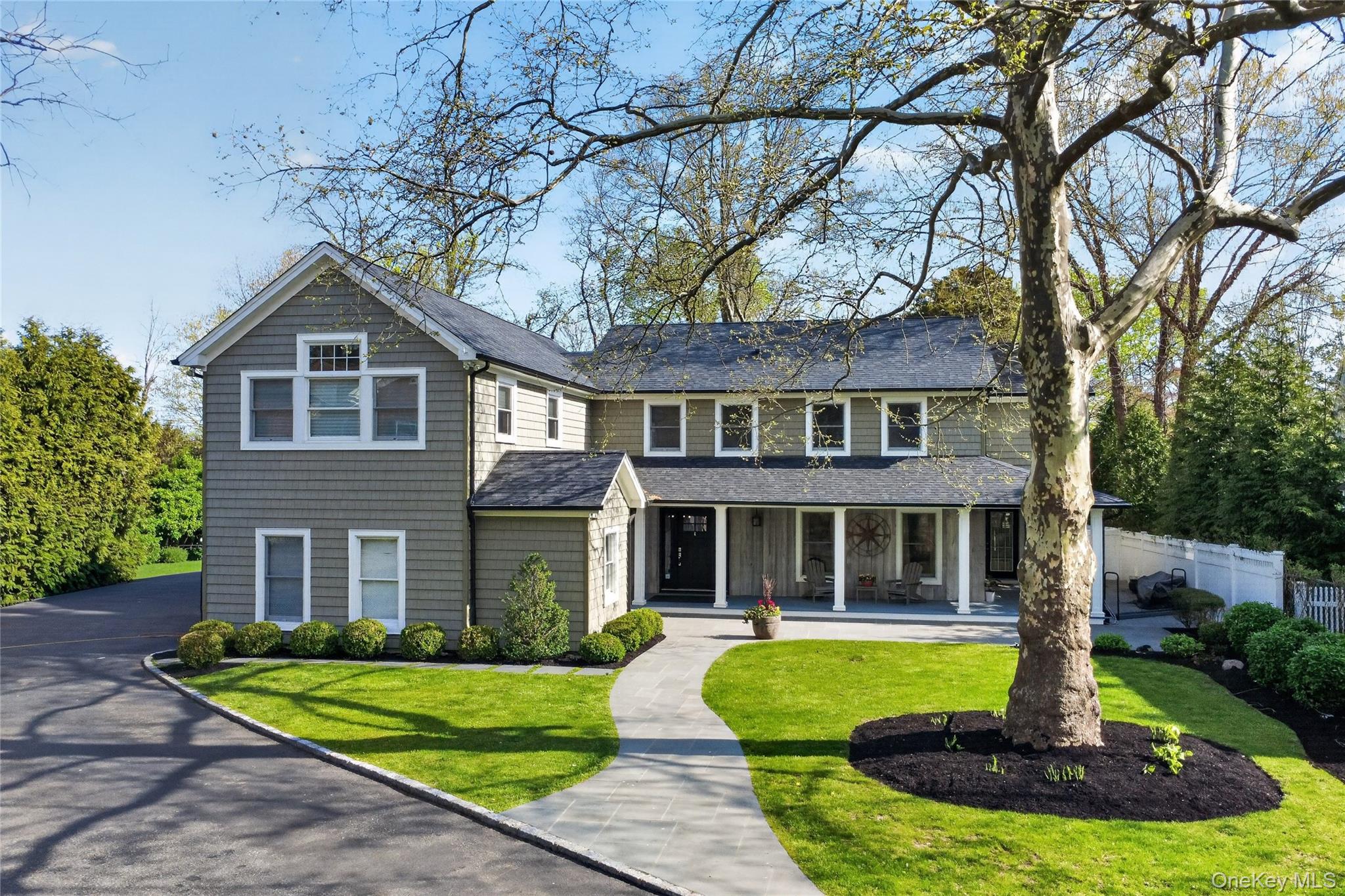 21 Midland Street Cold Spring Harbor, NY 11724 - Photo 2 of 44 a front view of a house with a yard and trees