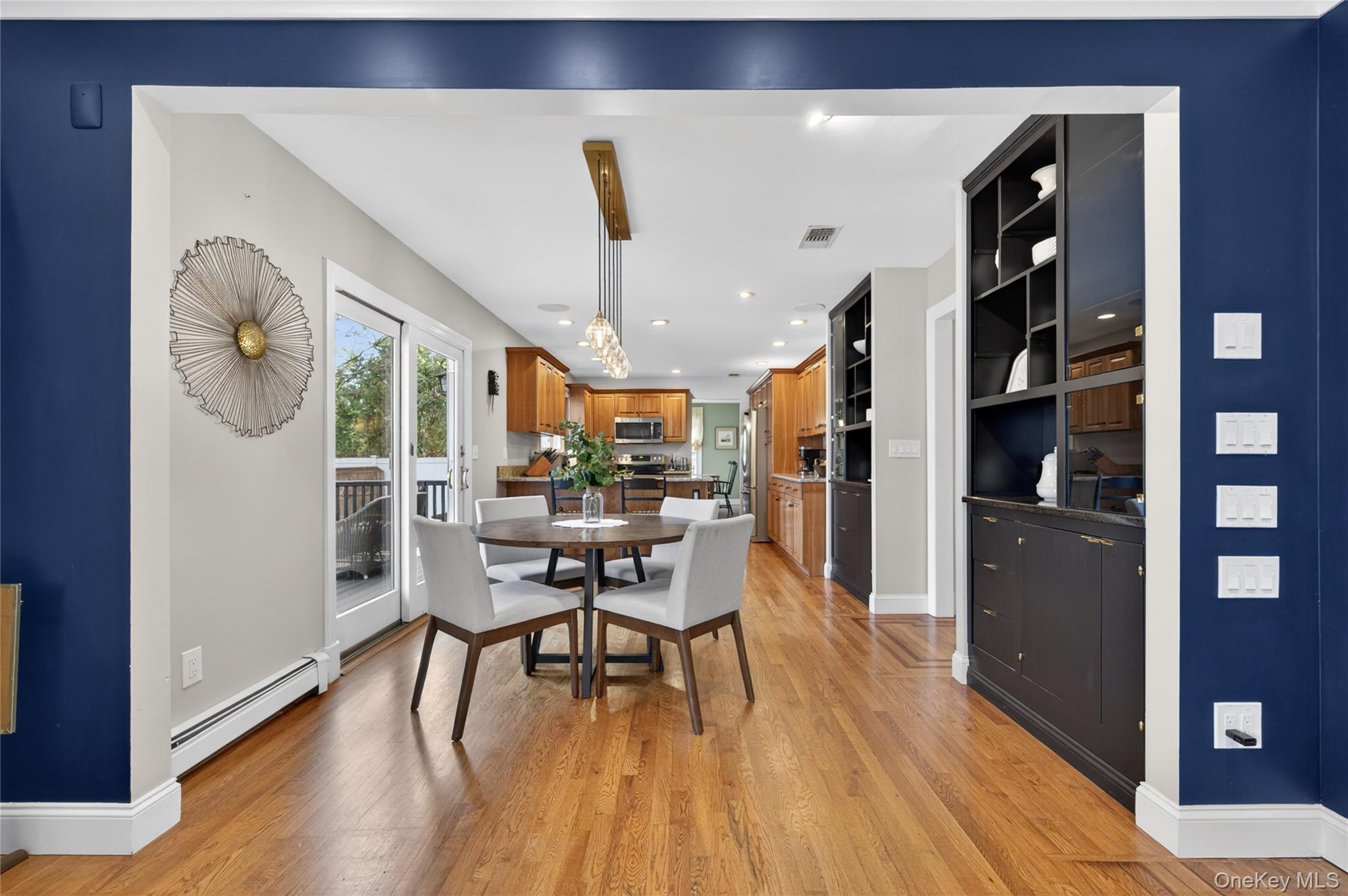 21 Midland Street Cold Spring Harbor, NY 11724 - Photo 21 of 44 a dining room with stainless steel appliances kitchen island a table and chairs