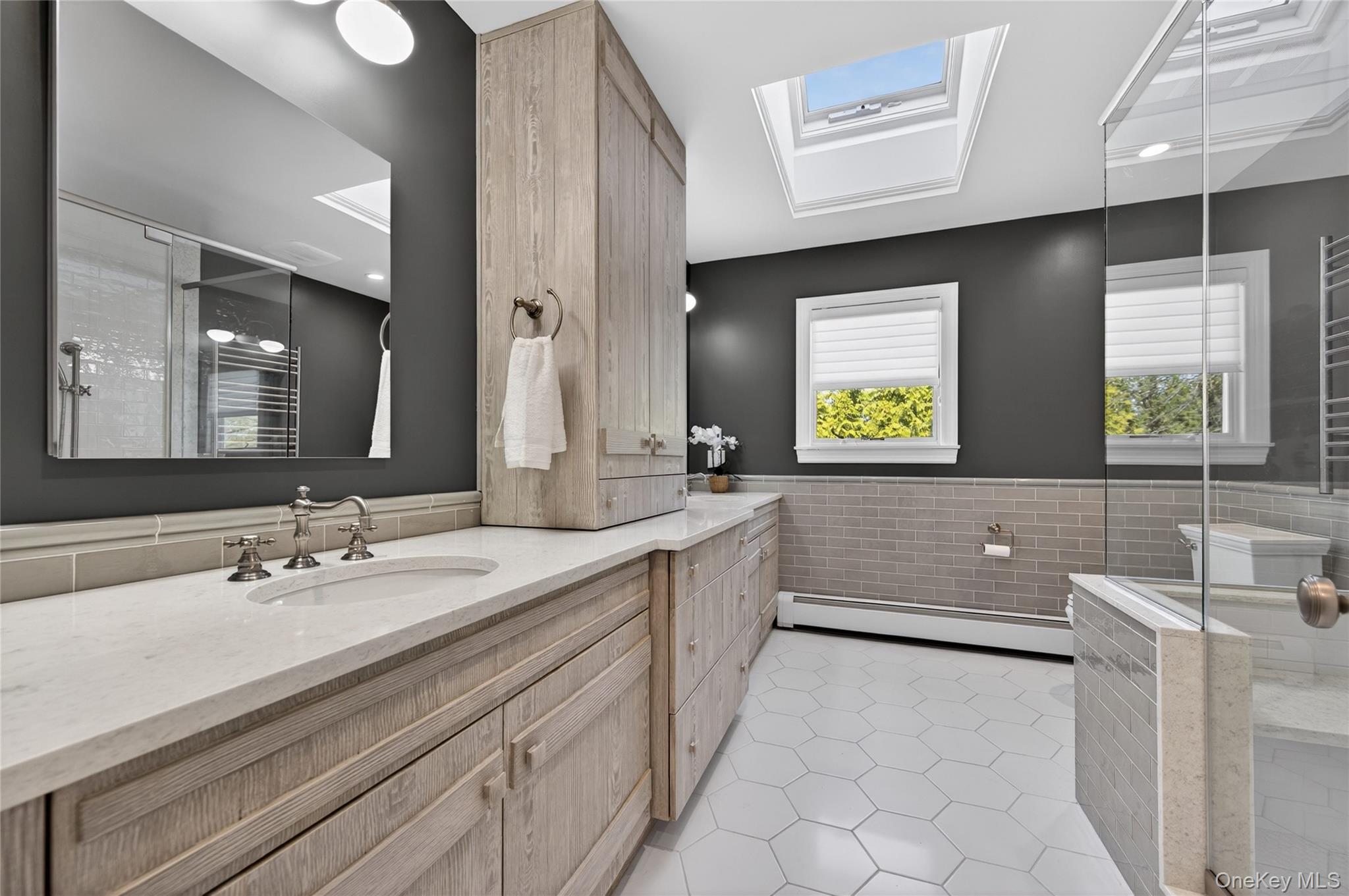 21 Midland Street Cold Spring Harbor, NY 11724 - Photo 25 of 44 a bathroom with a granite countertop sink mirror and a bathtub